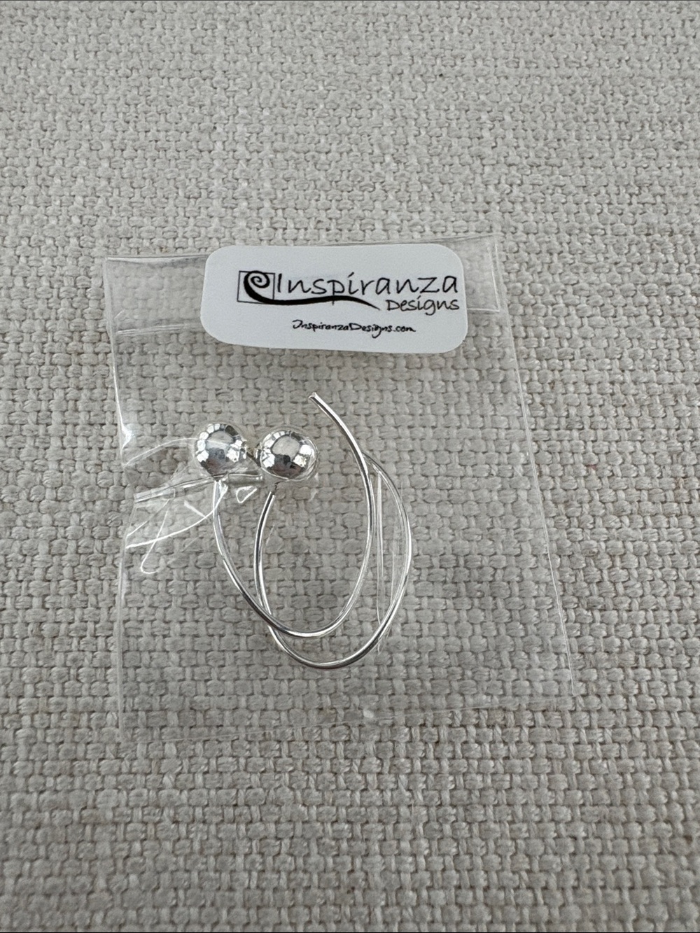 Silver Oval Shaped Earrings With Silver Round Ends. New in original packaging.